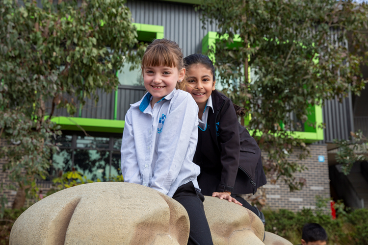Students playing at the dinosaur park